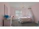 Charming bedroom with chandelier, crown molding and light pink paint at 2361 Rainy Lake St, Wake Forest, NC 27587