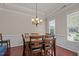 Formal dining room featuring hardwood floors, chandelier, and classic trim work, perfect for entertaining at 2361 Rainy Lake St, Wake Forest, NC 27587