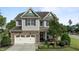 Charming two-story home featuring stone accents, a well-manicured lawn, and an attached two-car garage at 2361 Rainy Lake St, Wake Forest, NC 27587