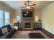 Inviting living room with a stone fireplace, a large television, and a comfortable leather sofa at 2361 Rainy Lake St, Wake Forest, NC 27587