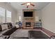 Inviting living room with a stone fireplace, large TV, plush sectional, and stylish decor at 2361 Rainy Lake St, Wake Forest, NC 27587