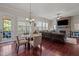 Open-concept living room featuring a stone fireplace, hardwood floors and abundant natural light at 2361 Rainy Lake St, Wake Forest, NC 27587