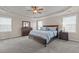 Spacious main bedroom featuring a tray ceiling, ceiling fan, and large windows at 2361 Rainy Lake St, Wake Forest, NC 27587