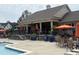 Community clubhouse with a pool and patio area, including seating, umbrellas, and landscaping at 2361 Rainy Lake St, Wake Forest, NC 27587