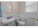 Clean powder room features a pedestal sink, white wainscoting and hardware at 2361 Rainy Lake St, Wake Forest, NC 27587