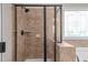 Custom tiled shower with black trim and hardware along with decorative glass block window at 2361 Rainy Lake St, Wake Forest, NC 27587