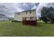 Backyard view of a two story house, including a deck, lawn, and landscaping at 2377 Vinson Rd, Clayton, NC 27527