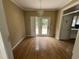 Spacious dining area with hardwood floors, a chandelier, and glass doors leading to the backyard at 2377 Vinson Rd, Clayton, NC 27527
