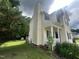 Side view of a two story home with vinyl siding, landscaped yard, and a front porch at 2377 Vinson Rd, Clayton, NC 27527