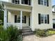 View of front porch with white railing, address 2377 on the window, and partial black door at 2377 Vinson Rd, Clayton, NC 27527