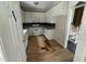 Kitchen with white cabinets, dated appliances, and some water damage on the floor needing repairs at 2377 Vinson Rd, Clayton, NC 27527