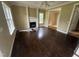 Spacious living room with hardwood floors, fireplace, and natural light at 2377 Vinson Rd, Clayton, NC 27527