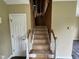 Unfinished staircase with exposed studs and wooden steps, ready for renovation and redesign at 2377 Vinson Rd, Clayton, NC 27527