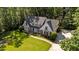 Aerial view of the property highlighting the manicured lawn, brick pathway, and mature trees at 2409 Beechview Ct, Raleigh, NC 27615