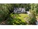 Aerial view of the home surrounded by lush trees, featuring a large lawn and a long driveway at 2409 Beechview Ct, Raleigh, NC 27615