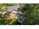 Aerial view of the home, showcasing the multi-level deck and lush backyard with mature trees at 2409 Beechview Ct, Raleigh, NC 27615