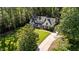 Aerial shot of the home, showcasing its sprawling lawn, mature trees, and driveway at 2409 Beechview Ct, Raleigh, NC 27615