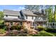 Exterior rear elevation highlighting a brick foundation, siding, deck, and landscaped backyard at 2409 Beechview Ct, Raleigh, NC 27615