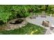 Backyard patio area featuring wooden chairs, a fire pit, and a tranquil water feature at 2409 Beechview Ct, Raleigh, NC 27615