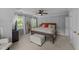 Cozy bedroom with hardwood floors, neutral paint, and natural light from the large windows at 2409 Beechview Ct, Raleigh, NC 27615