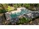 A beautiful community pool featuring a fenced in pool area with abundant lounging chairs and nearby shady seating at 2409 Beechview Ct, Raleigh, NC 27615