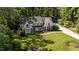 An attractive brick home with a welcoming front porch and beautifully landscaped front yard surrounded by mature trees at 2409 Beechview Ct, Raleigh, NC 27615