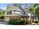 Rear exterior view, showcasing the home's architectural details, two-car garage and back deck at 2409 Beechview Ct, Raleigh, NC 27615