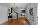 Welcoming foyer with hardwood floors and staircase at 2409 Beechview Ct, Raleigh, NC 27615
