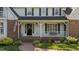 Inviting front porch with brick steps and charming decor at 2409 Beechview Ct, Raleigh, NC 27615