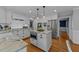 Bright kitchen featuring an island with seating, stainless steel appliances, and custom cabinets at 2409 Beechview Ct, Raleigh, NC 27615