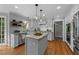 Charming kitchen featuring custom cabinets, an island, granite counters, and stainless steel appliances at 2409 Beechview Ct, Raleigh, NC 27615