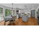 Bright kitchen featuring an island with seating and stainless steel appliances at 2409 Beechview Ct, Raleigh, NC 27615
