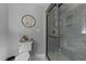 Well appointed lavatory with grey tones, a shower with glass door and ceramic tile at 2409 Beechview Ct, Raleigh, NC 27615