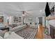 Spacious living room with a fireplace, built-in bookshelves, and hardwood floors at 2409 Beechview Ct, Raleigh, NC 27615