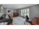 Cozy living room with a piano and ample natural light at 2409 Beechview Ct, Raleigh, NC 27615