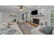 Bright living room showcasing a fireplace, wood floors, and comfortable seating at 2409 Beechview Ct, Raleigh, NC 27615