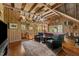 Spacious game room with wood paneled walls, a pool table, cozy seating, and ample natural light at 2409 Beechview Ct, Raleigh, NC 27615