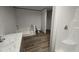 Modern bathroom featuring a combined tub/shower and separate walk-in shower, and stylish flooring at 2668 Bodie Currin Rd, Oxford, NC 27565