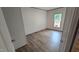 Bright bedroom features woodgrain flooring and a window with view to green outdoor space at 2668 Bodie Currin Rd, Oxford, NC 27565