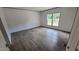Bright bedroom features woodgrain flooring and dual windows with green outdoor views at 2668 Bodie Currin Rd, Oxford, NC 27565