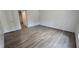 Bright bedroom featuring wood-look vinyl floors and an adjacent bathroom, offering comfort and convenience at 2668 Bodie Currin Rd, Oxford, NC 27565