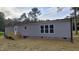 Well maintained single-story home with gray siding, wood deck, and professionally landscaped yard at 2668 Bodie Currin Rd, Oxford, NC 27565