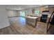 Bright, open kitchen with modern appliances, an island with a white countertop, and wood-look vinyl flooring at 2668 Bodie Currin Rd, Oxford, NC 27565