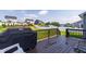 View of the back deck area, overlooking a wide backyard and beautiful houses at 272 High Woods Rdg, Chapel Hill, NC 27517