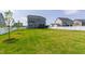Wide grassy backyard featuring well-maintained grass, houses, and mature trees at 272 High Woods Rdg, Chapel Hill, NC 27517