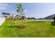 Large grassy backyard with well-maintained lawn and a white fence surrounding the perimeter at 272 High Woods Rdg, Chapel Hill, NC 27517
