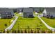 Aerial view of a spacious backyard with a deck, surrounded by a fence and neighboring houses at 272 High Woods Rdg, Chapel Hill, NC 27517