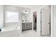 Luxurious bathroom features a bathtub, a separate shower, a dual sink vanity, and marble-like tile flooring at 272 High Woods Rdg, Chapel Hill, NC 27517