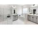 Luxurious bathroom features a bathtub, a separate shower, a dual sink vanity, and marble-like tile flooring at 272 High Woods Rdg, Chapel Hill, NC 27517