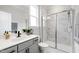 Bright bathroom featuring an updated shower with glass doors, a marble-tiled shower and flooring, and a modern vanity at 272 High Woods Rdg, Chapel Hill, NC 27517